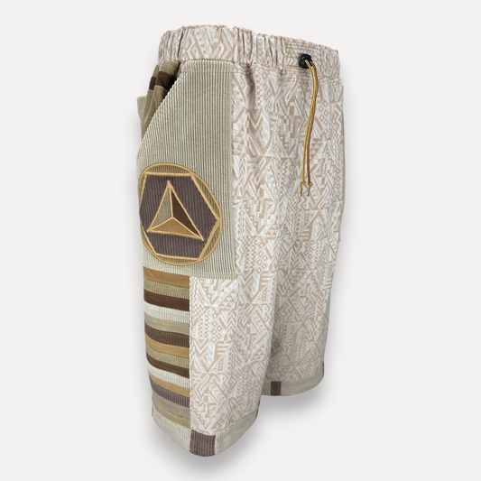 nowAwear medium length shorts in beige and brown cotton with geometric patterns, corduroy panels, and triangle patch