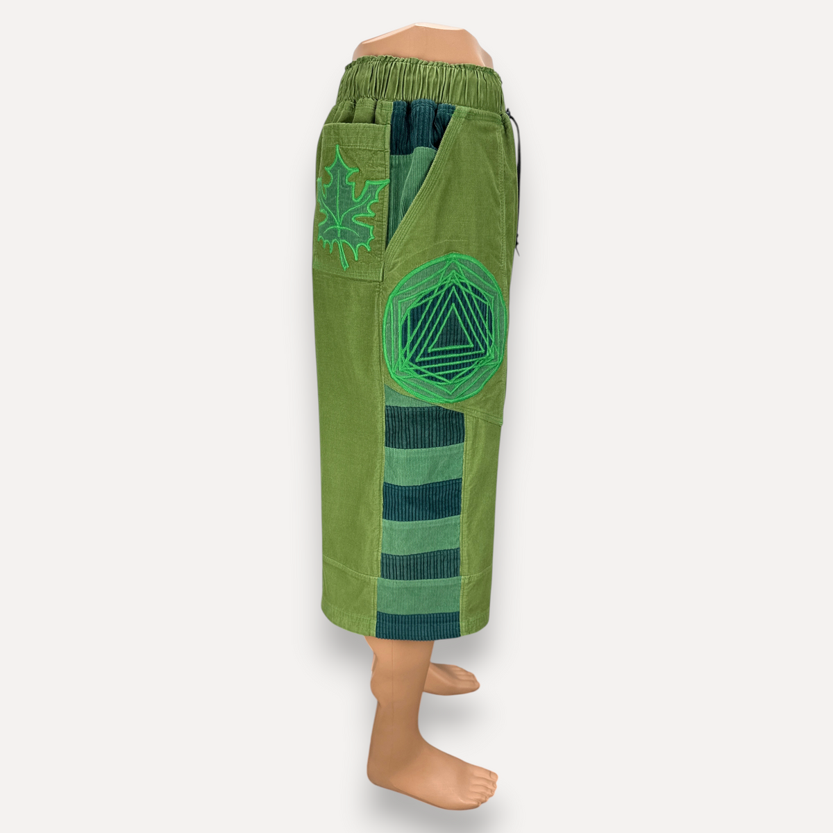 nowAwear medium green corduroy shorts featuring leaf embroidery, geometric patch, and striped side panel detail