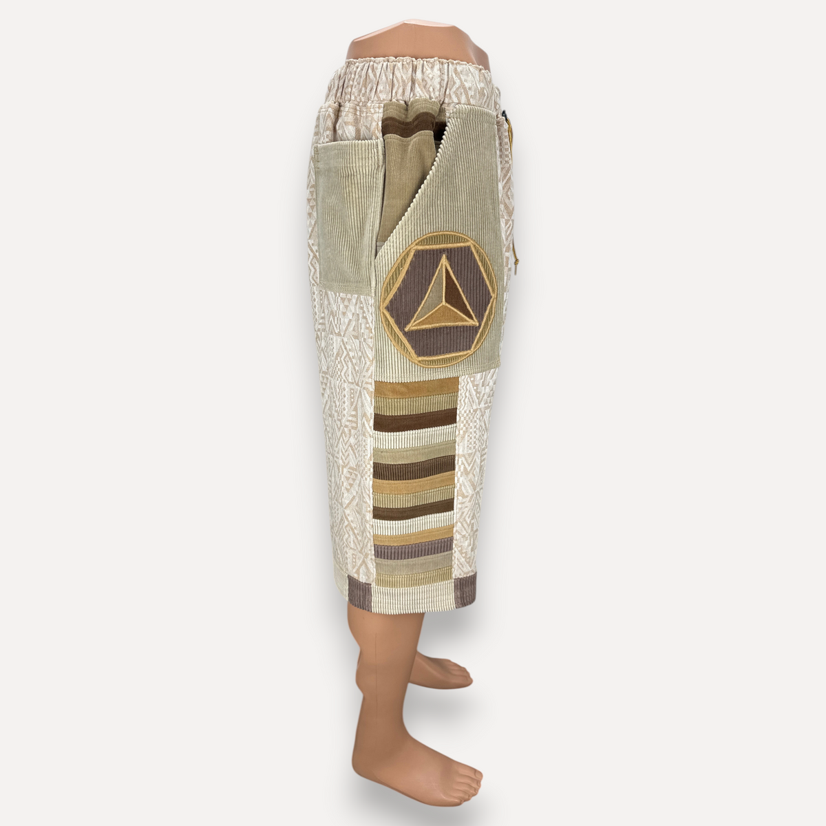 nowAwear medium length shorts in beige and brown cotton featuring geometric patterns, corduroy panels, and a patch.