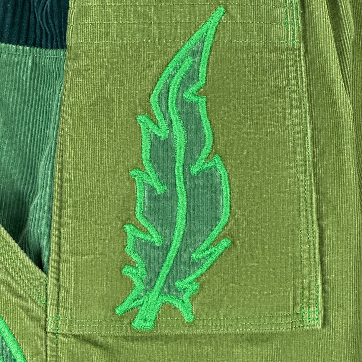 nowAwear medium green corduroy shorts featuring a detailed embroidered leaf design on the pocket