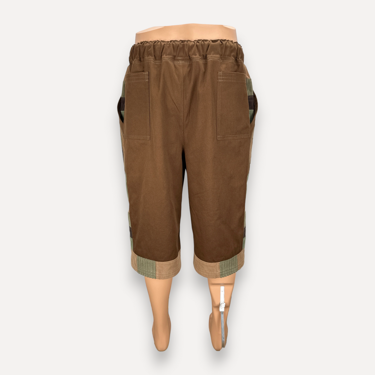 nowAwear brown twill shorts with an elastic waistband, side pockets, and contrasting green and tan hem detailing.