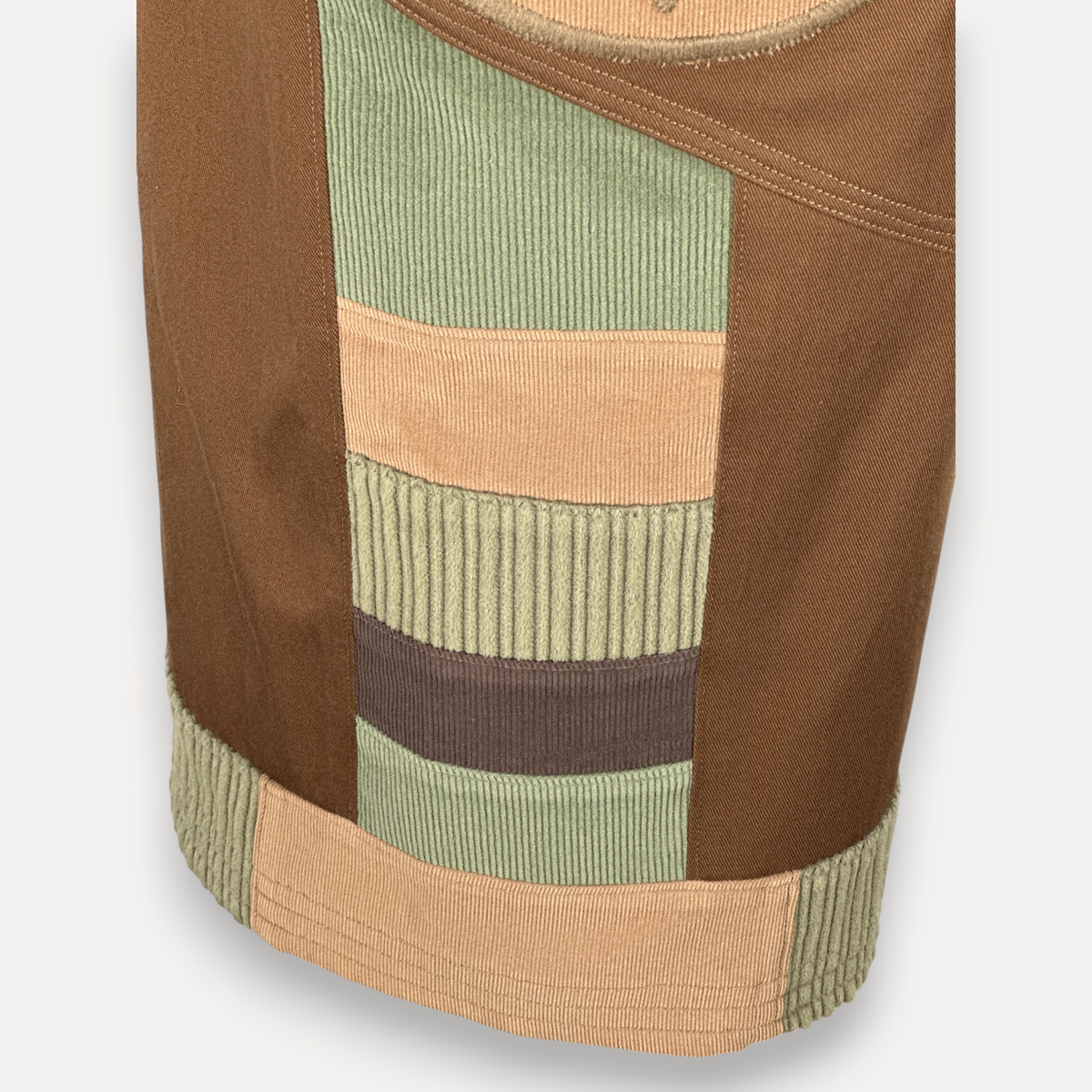 nowAwear brown twill shorts featuring a patchwork design with sage green and tan corduroy panels