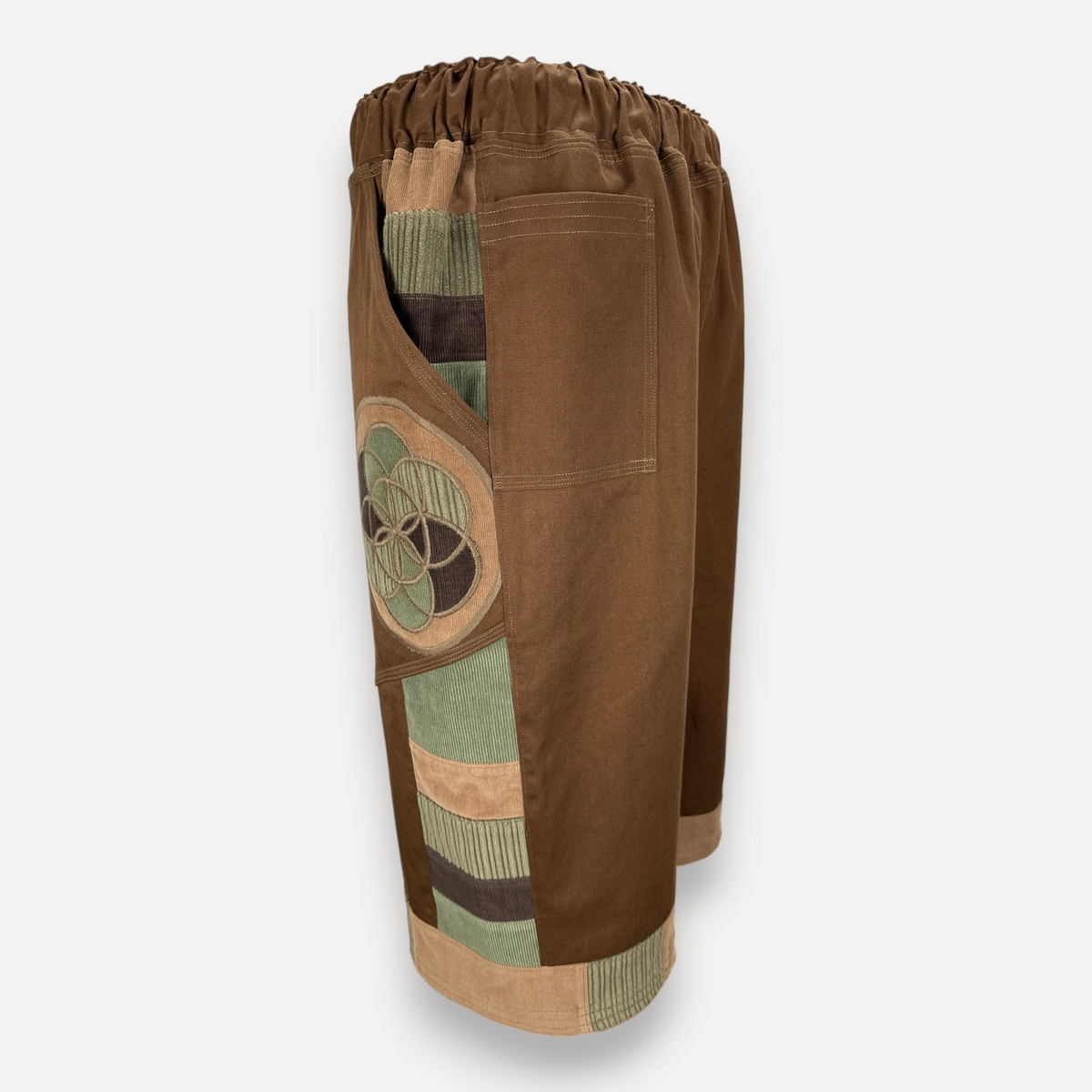 nowAwear brown twill shorts featuring a side pocket with green and brown corduroy patchwork and circular embroidery
