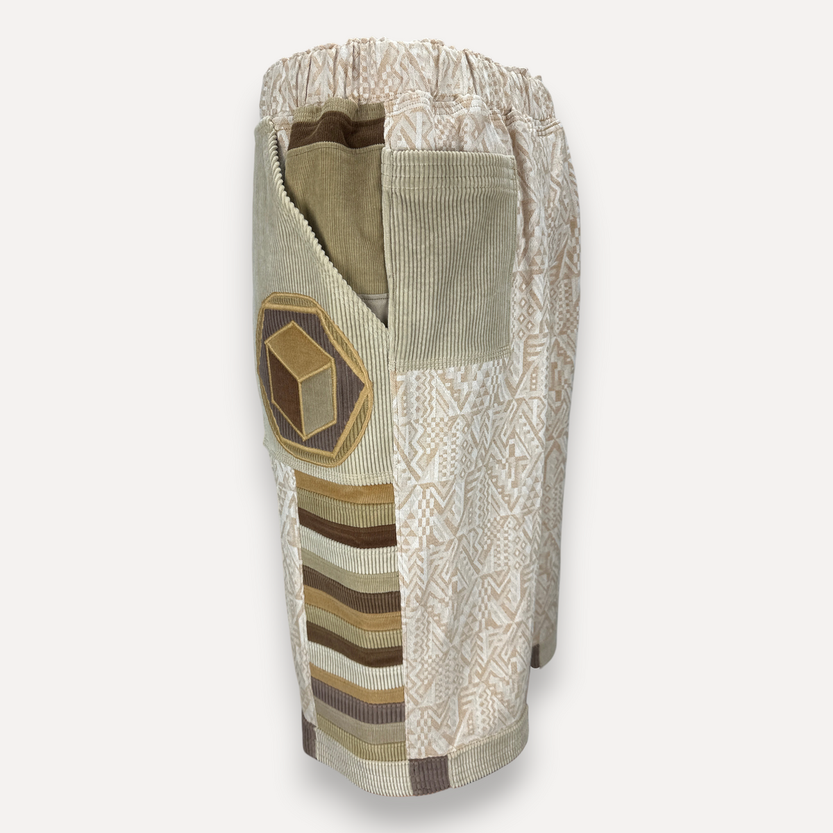 nowAwear medium length cotton shorts featuring geometric patterns, corduroy panels, and a hexagonal patch pocket.