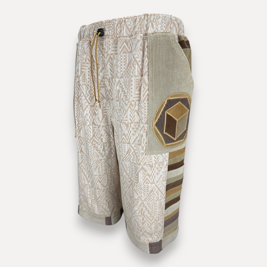 nowAwear medium length cotton shorts featuring geometric patterns, corduroy side panels, and a cube patch detail.