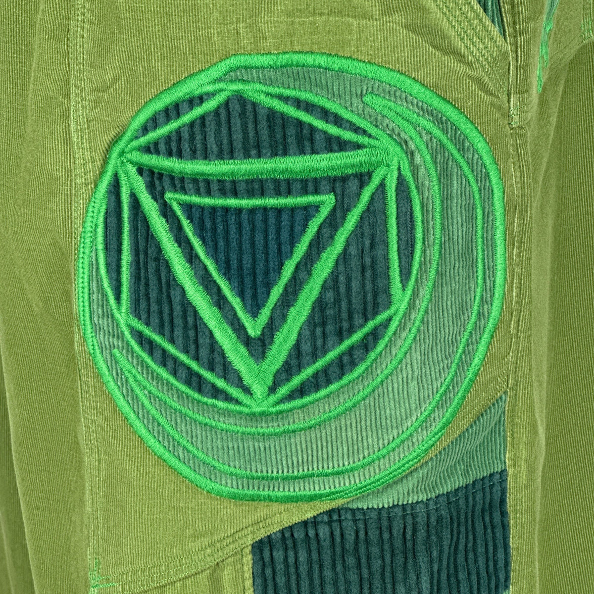nowAwear medium green corduroy shorts featuring a large circular geometric embroidered patch detail