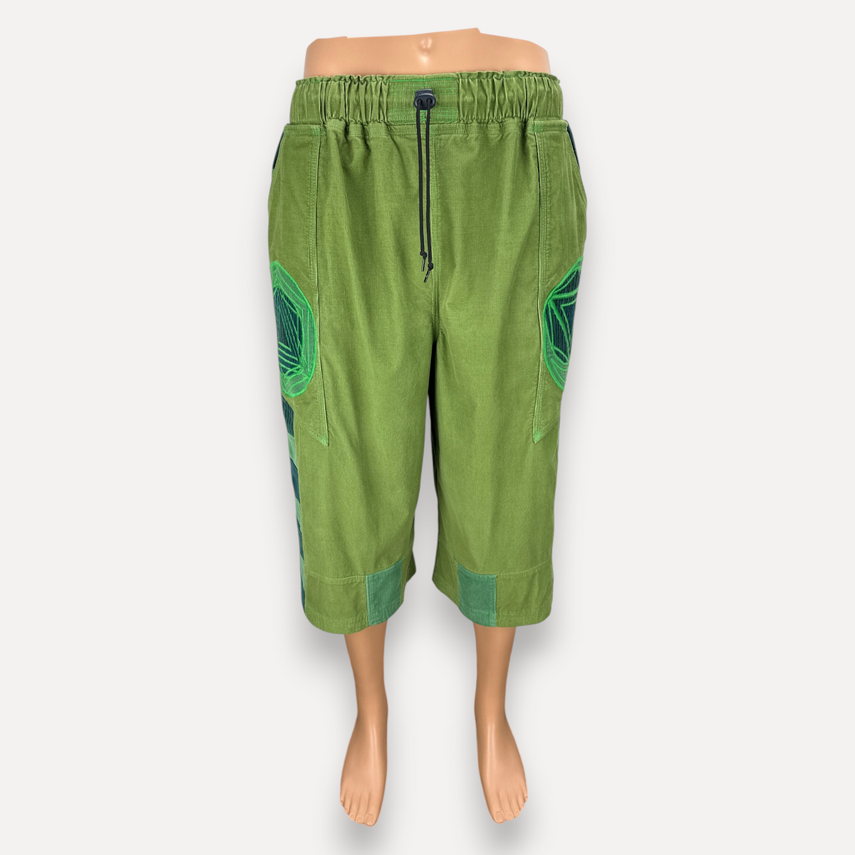 nowAwear medium green cotton shorts with an elastic drawstring waist and decorative geometric side panel detailing.