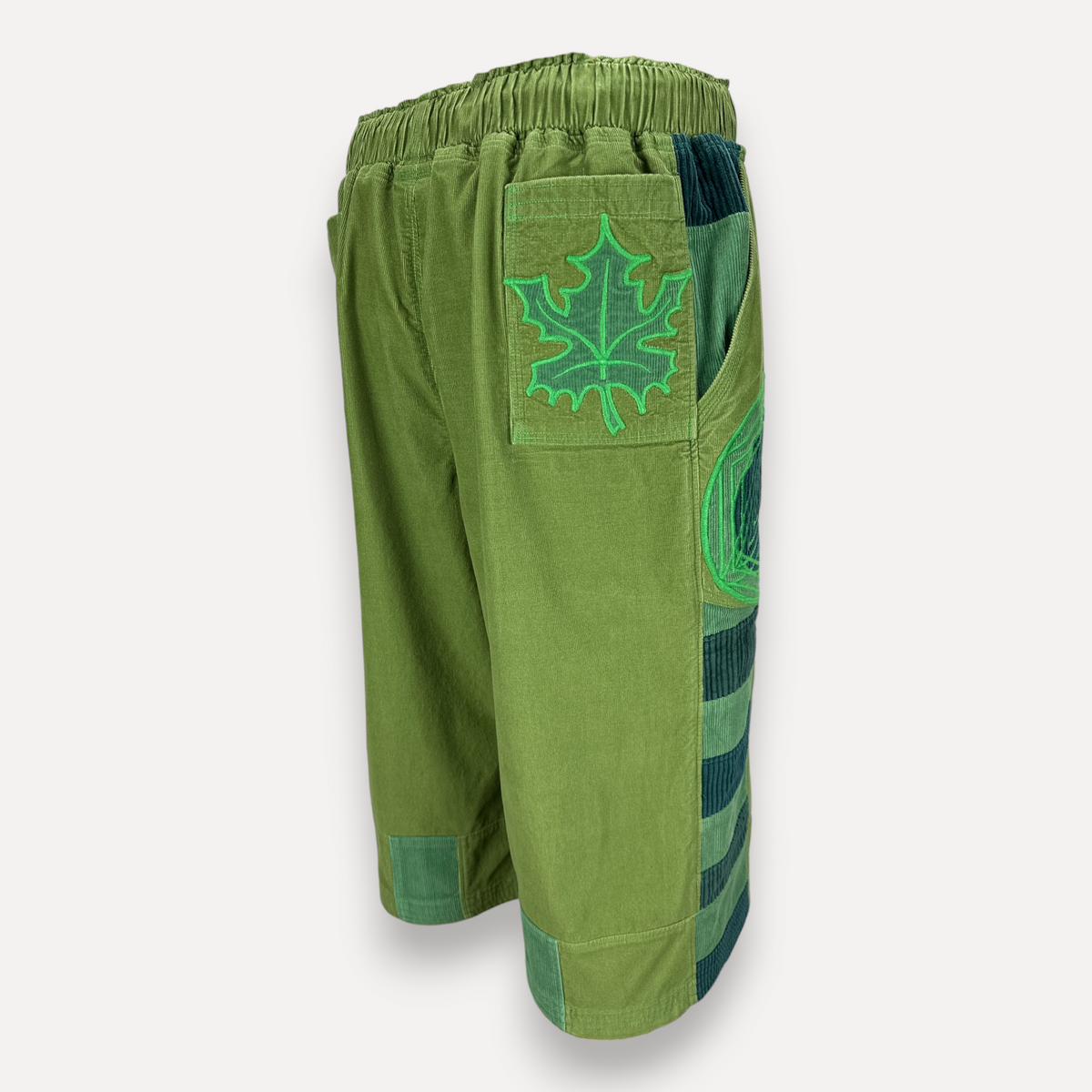 nowAwear medium green corduroy shorts featuring a leaf embroidery patch and striped side panel detail