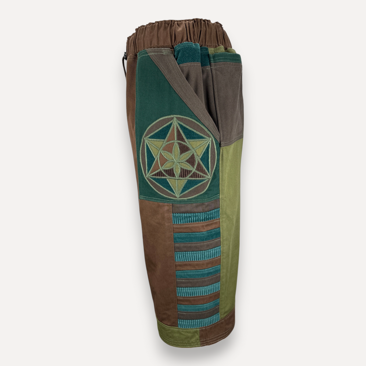 nowAwear medium brown and green shorts featuring a geometric flower of life embroidery and ribbed panel detailing.