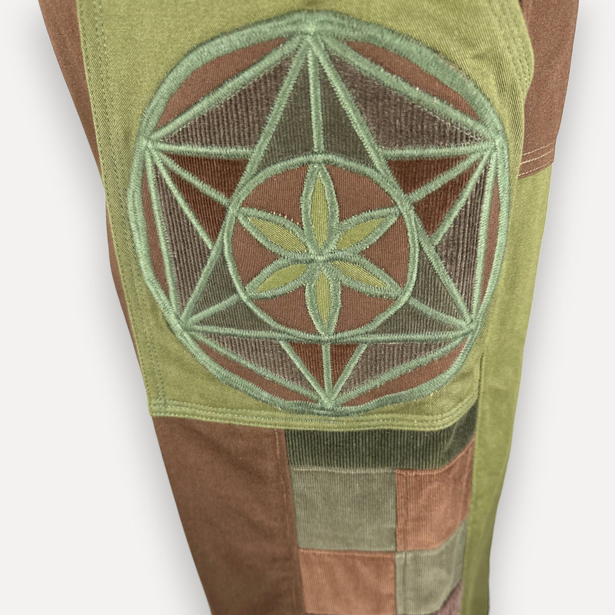 nowAwear olive and brown corduroy shorts featuring a large embroidered sacred geometry flower of life patch