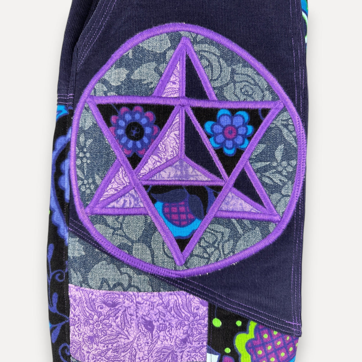 nowAwear corduroy shorts featuring a purple embroidered star patch over a patchwork floral and paisley design