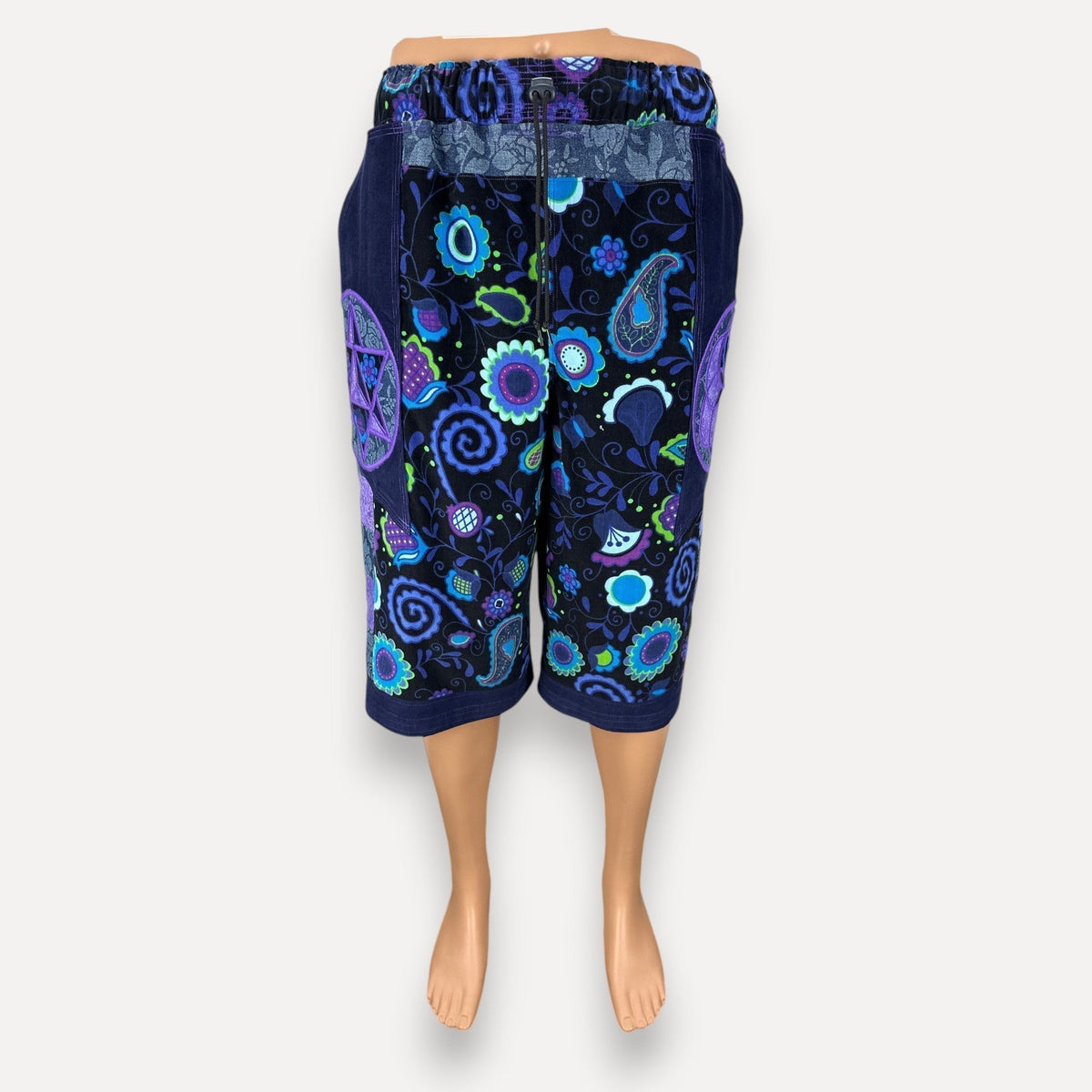 nowAwear shorts featuring a vibrant blue and purple floral paisley pattern with a drawstring waist and side pockets