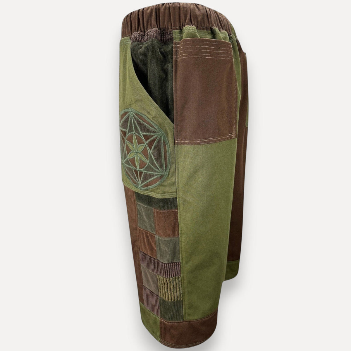 nowAwear patchwork shorts in olive green and brown corduroy with a geometric flower of life embroidery detail