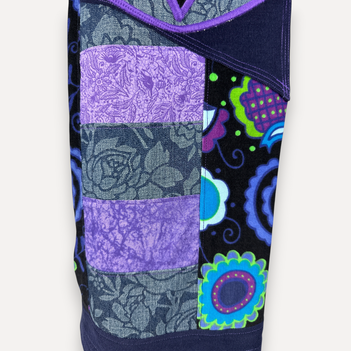 nowAwear shorts featuring a vibrant patchwork design with purple floral denim and black fabric with colorful flowers