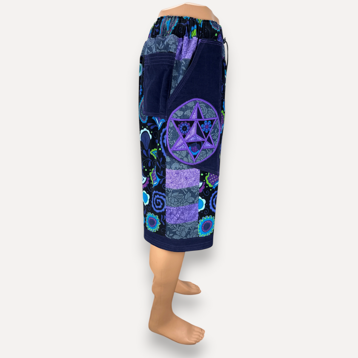 nowAwear patchwork shorts in navy blue and purple with floral patterns and a prominent star applique side pocket