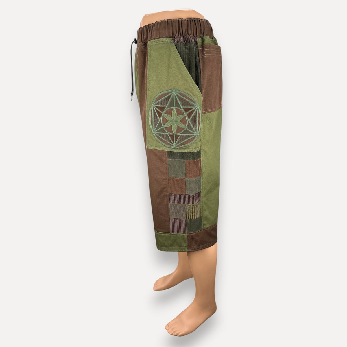 nowAwear patchwork shorts in olive green and brown with a geometric flower embroidery on the side pocket